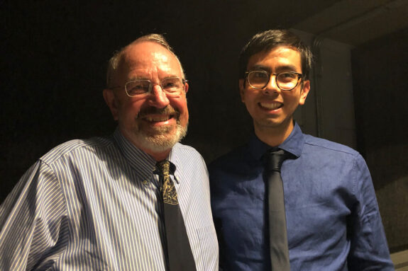 Roger Summons and Angel Mojarro stand together and smile at the camera.