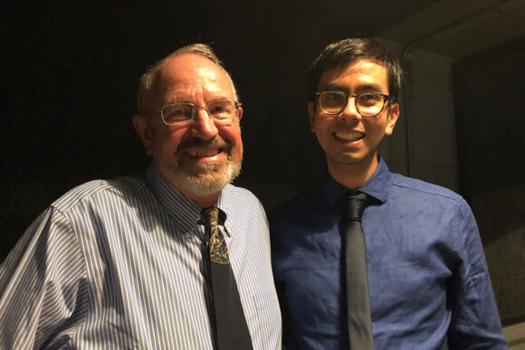 Roger Summons and Angel Mojarro stand together and smile at the camera.