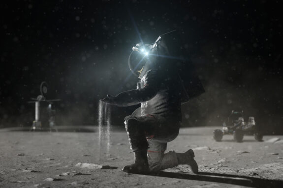 Moon dust falls through the hands of an astronaut.