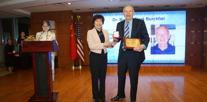 B. Clark Burchfiel accepting award from Chinese Ambassador Zhang Qiyue